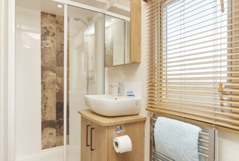 shower room with sink and slatted blinds in The Chantry Lodge