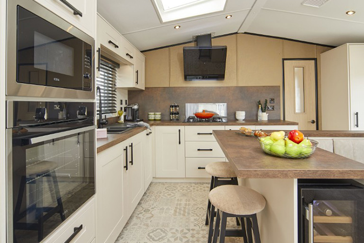 Fully fitted Kitchen with island and two stools in the Grantley Lodge