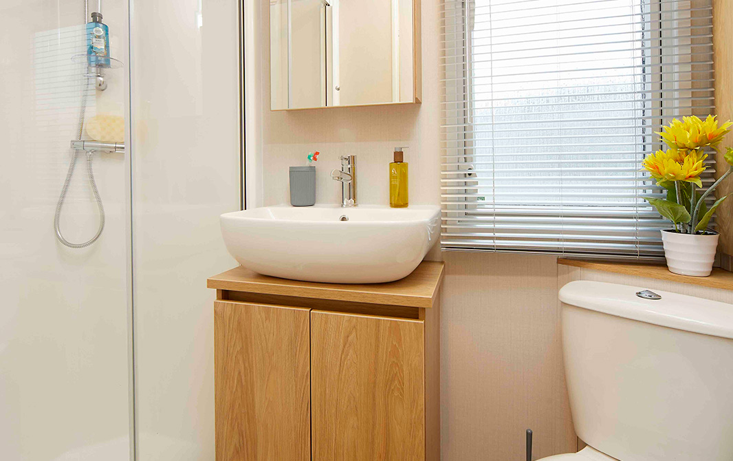 Shower room with basen and toilet in The Melrose caravan