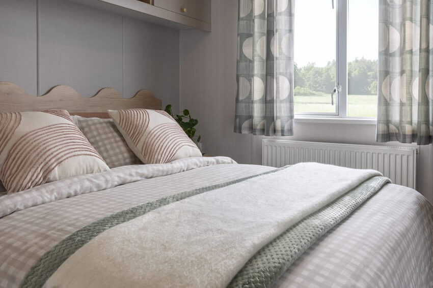 Master bedroom with King size bed in the Burgundy caravan