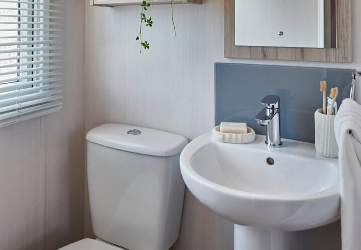 Modern Water closet with toilet and sink in the Loire caravan