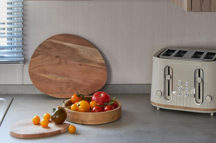 walnut unites with a bowl of tomatos on the worktop in the Loire caravan