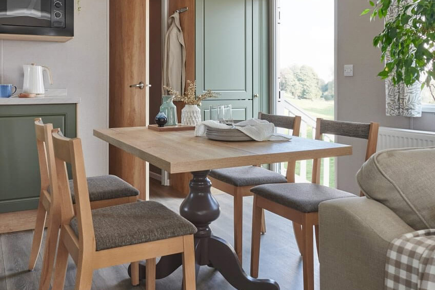 Wodden dining table and chairs in the Provence Caravan
