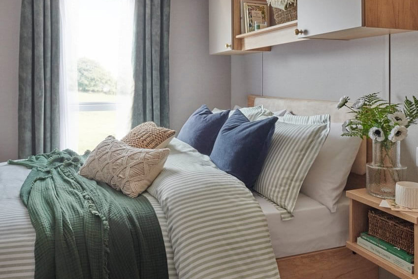 Master bedroom with large window in the Provence Caravan